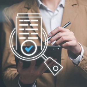 A professional man using a tablet with a magnifying glass and a check mark